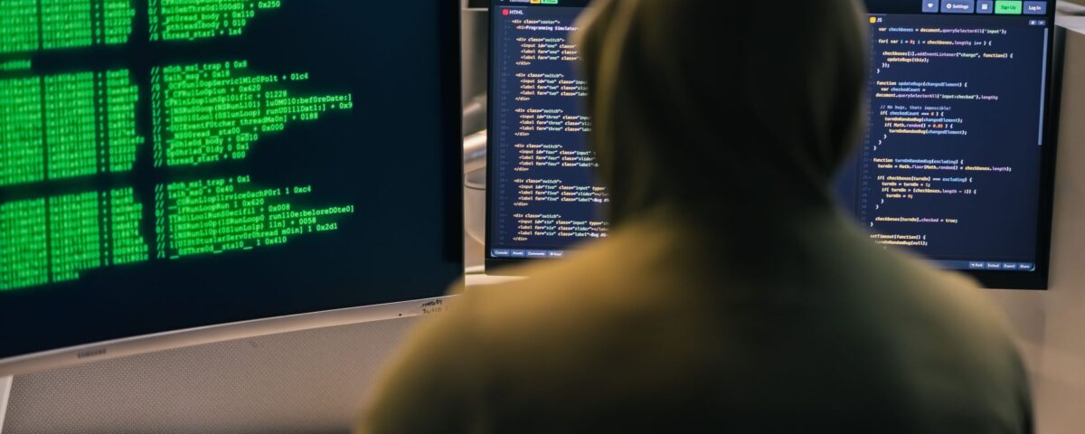 Cyberattack warning alerts overlaying industrial PLM engineering blueprints on screens