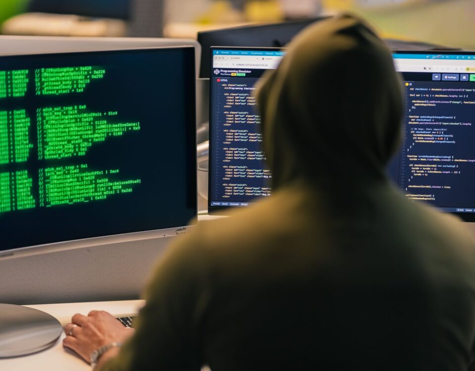 Cyberattack warning alerts overlaying industrial PLM engineering blueprints on screens