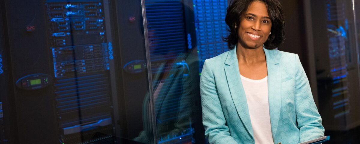 Network engineer reviewing firewall rule policy on server rack monitor