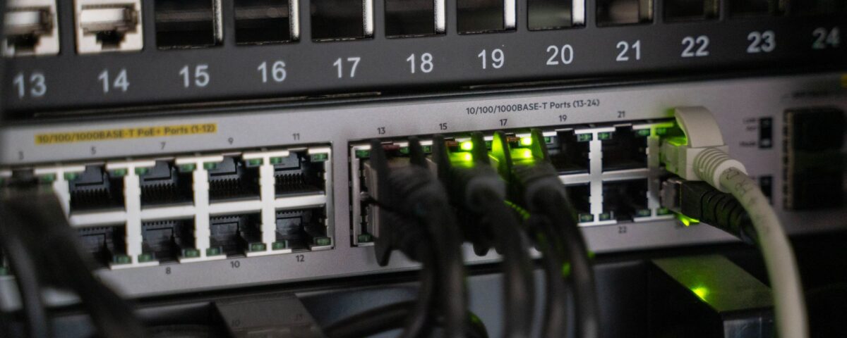 Small business server rack with security monitoring dashboard on nearby desk