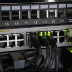 Small business server rack with security monitoring dashboard on nearby desk