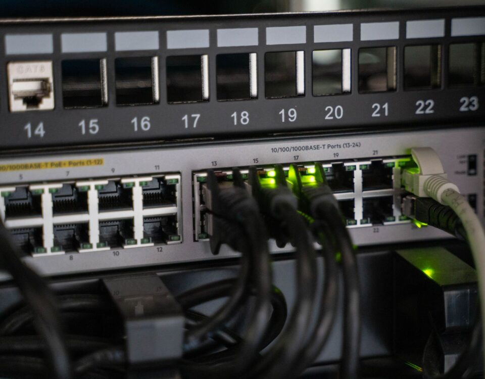 Small business server rack with security monitoring dashboard on nearby desk