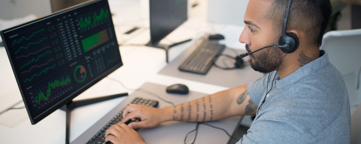 Security analyst reviewing endpoint threat detection dashboards on dual monitors