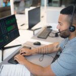 Security analyst reviewing endpoint threat detection dashboards on dual monitors