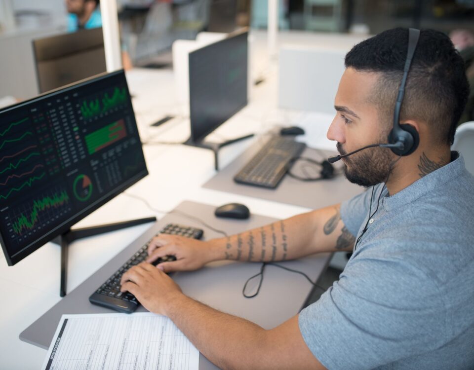 Security analyst reviewing endpoint threat detection dashboards on dual monitors