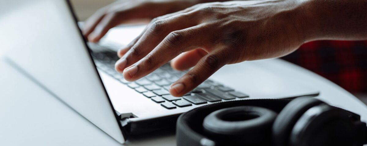 Person examining suspicious login alert on laptop security screen
