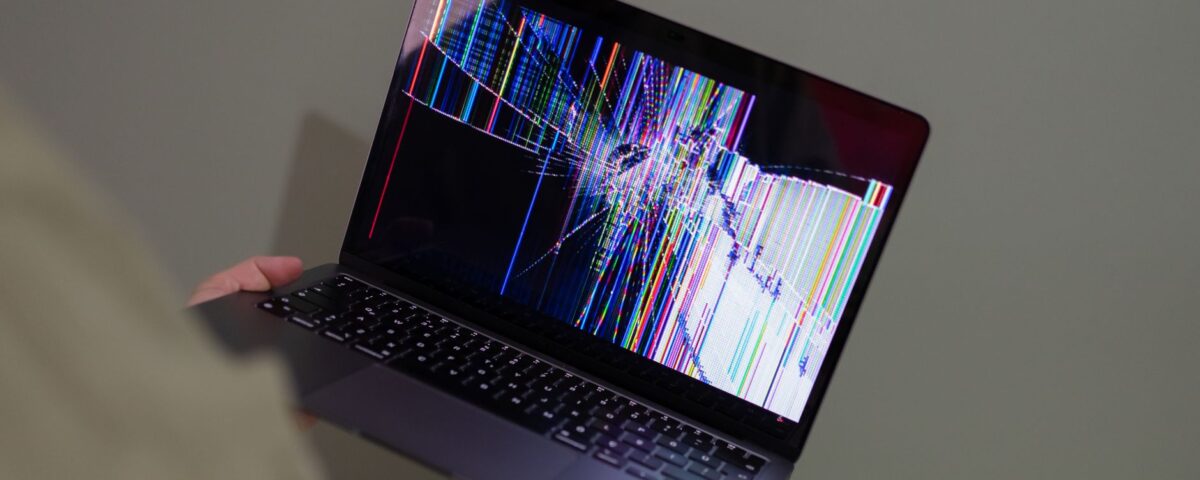 Laptop screen showing alternating corrupted and intact files in a folder