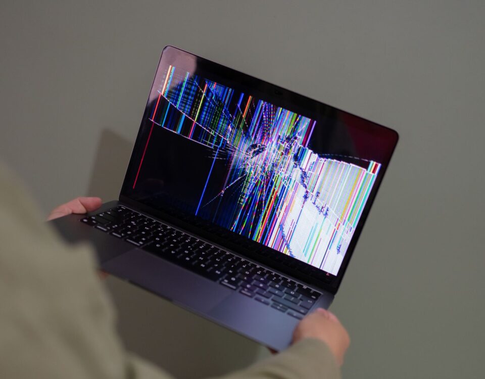 Laptop screen showing alternating corrupted and intact files in a folder