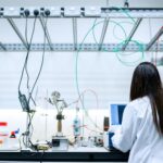 Security researcher analyzing adversarial machine learning model output charts in laboratory