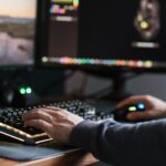 Robotic arm pressing keyboard keys in a server room environment
