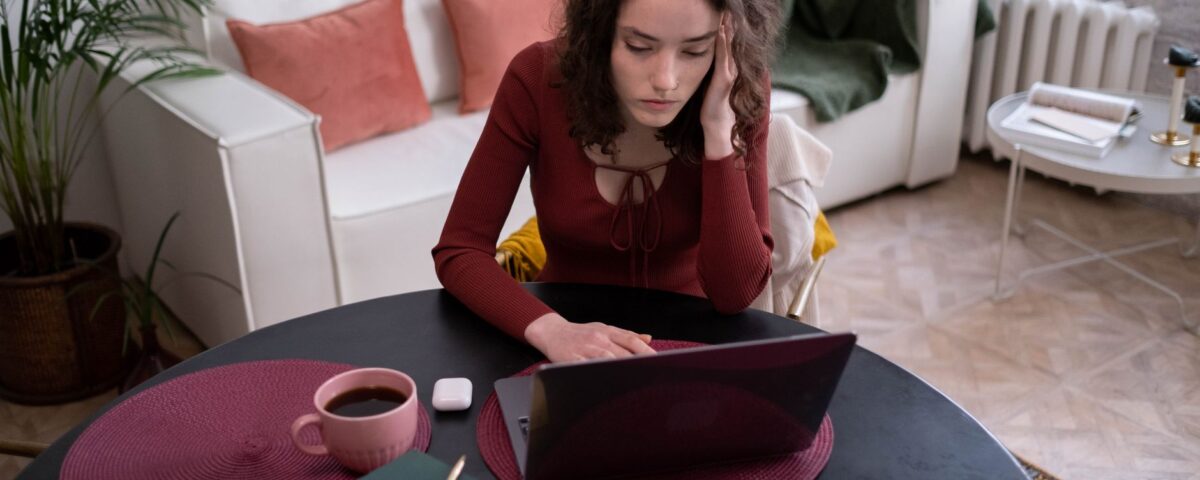 Office professional scrutinizing a suspicious phishing email on laptop screen