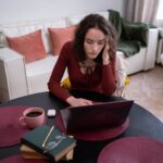 Office professional scrutinizing a suspicious phishing email on laptop screen