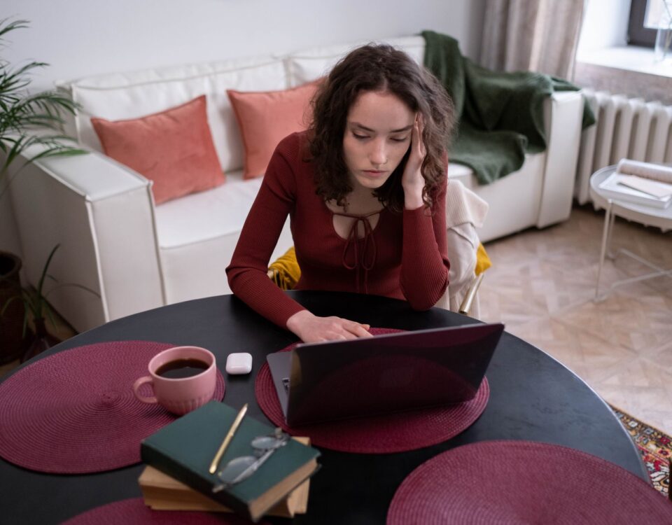 Office professional scrutinizing a suspicious phishing email on laptop screen