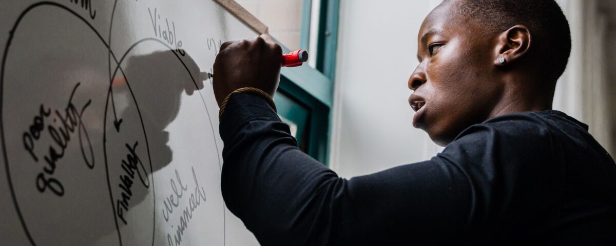 Security analyst reviewing AI-generated threat model attack path diagram on whiteboard