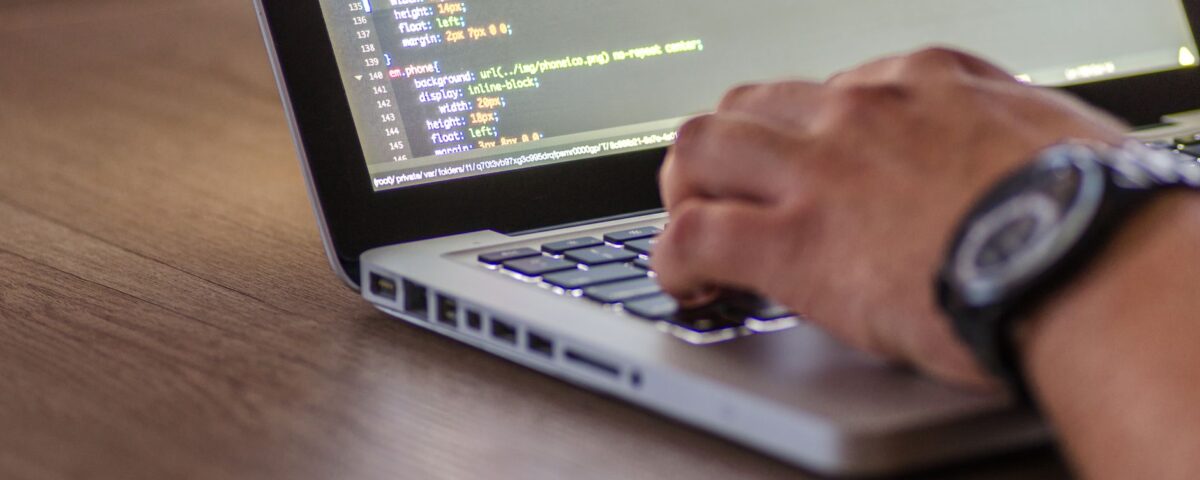 Developer at terminal screens displaying code during AI security red-team session