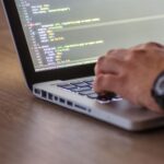 Developer at terminal screens displaying code during AI security red-team session