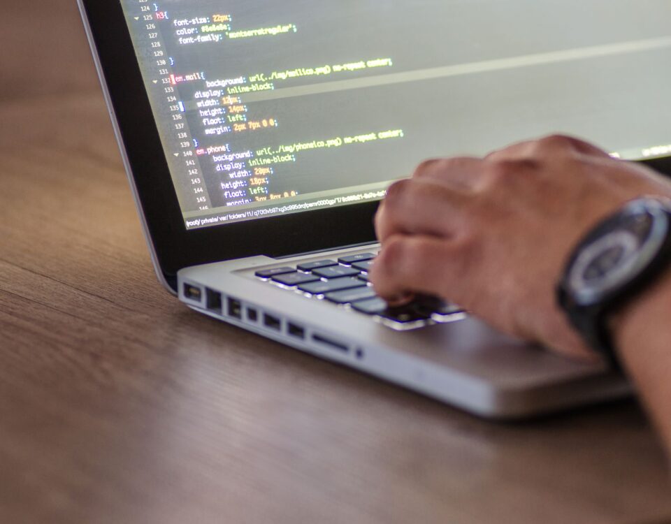Developer at terminal screens displaying code during AI security red-team session