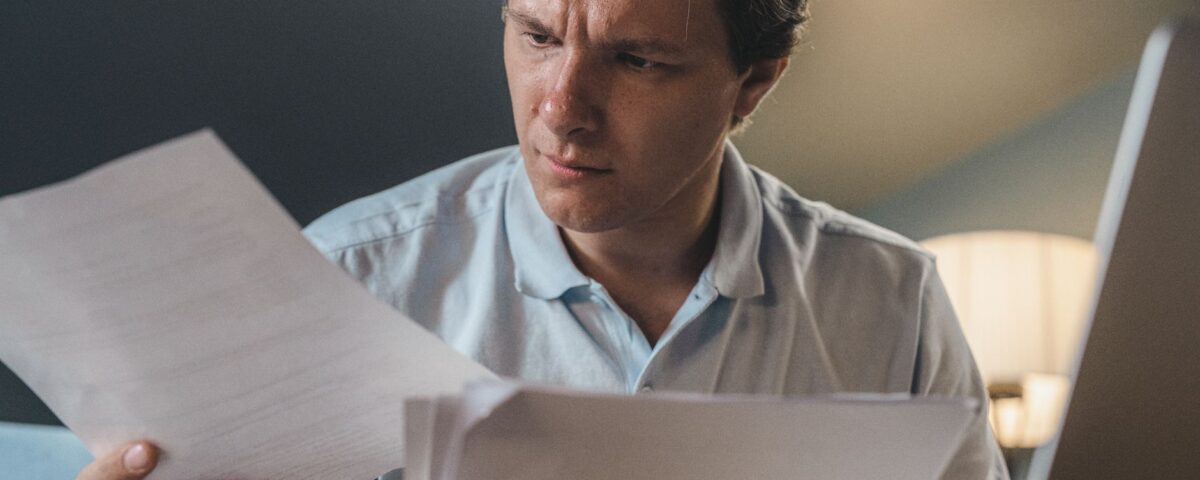 Security analyst reading a document containing hidden prompt injection payload at desk
