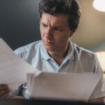 Security analyst reading a document containing hidden prompt injection payload at desk