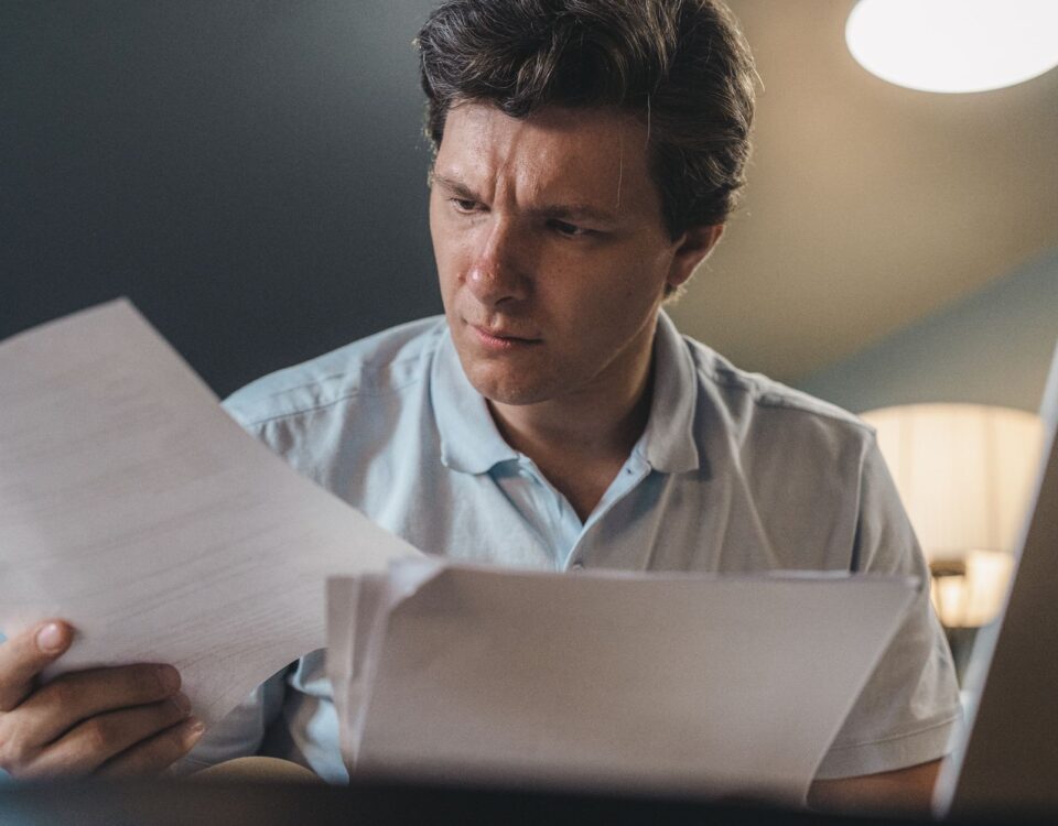 Security analyst reading a document containing hidden prompt injection payload at desk