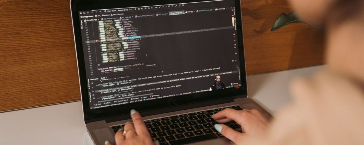 Developer laptop showing AI-assisted code editor with multiple open files