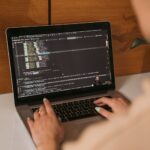 Developer laptop showing AI-assisted code editor with multiple open files