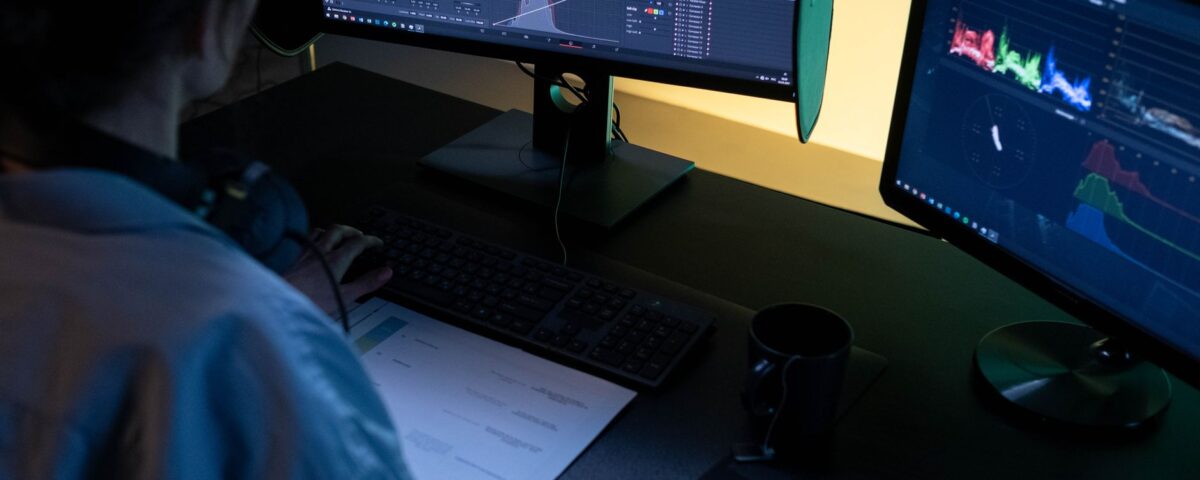 Security analyst examining video authentication data across multiple monitors