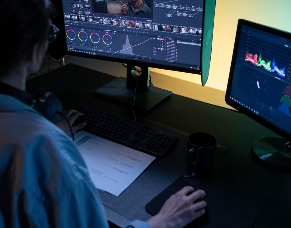 Security analyst examining video authentication data across multiple monitors