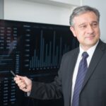 Security analyst reviewing AI threat logs on multiple monitor screens