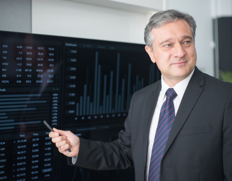 Security analyst reviewing AI threat logs on multiple monitor screens