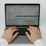 Security engineer reviewing AI prompt input and output logs on monitors