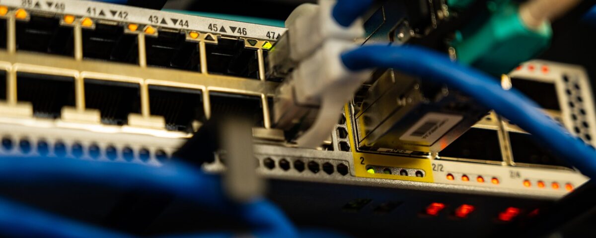 Enterprise server rack with dense colored network cables and blinking LED indicators