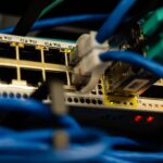 Enterprise server rack with dense colored network cables and blinking LED indicators