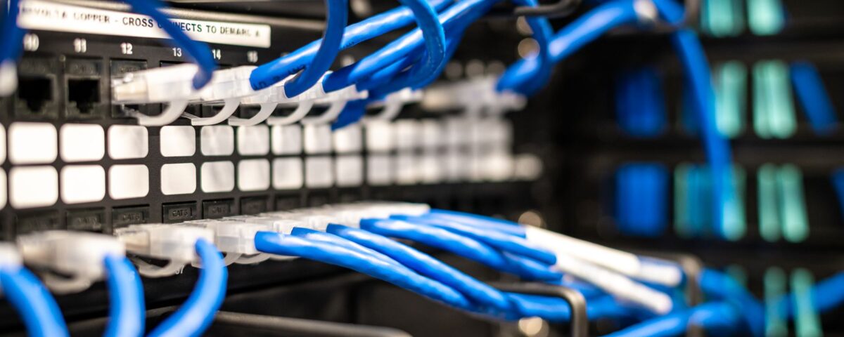 Data center server rack with glowing indicator lights and cable management