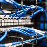 Data center server rack with glowing indicator lights and cable management