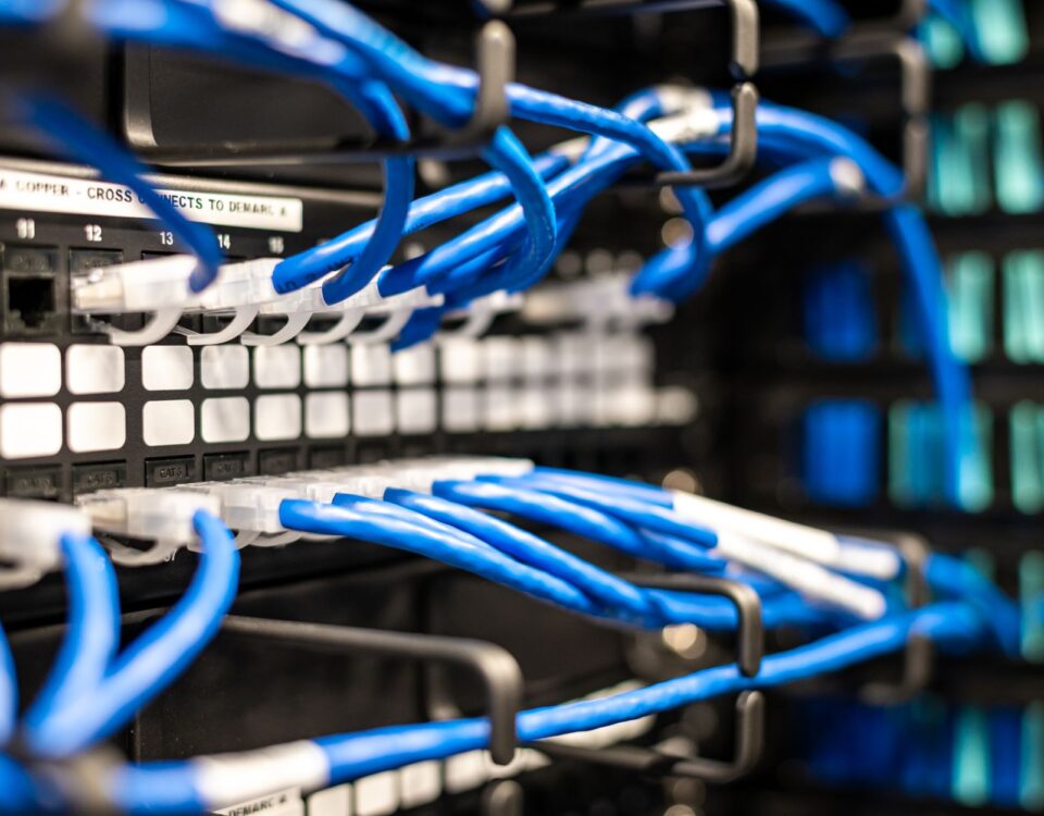Data center server rack with glowing indicator lights and cable management