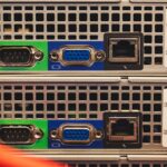 Multiple server racks connected by fiber optic cables in enterprise data center