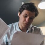 Security analyst carefully reviewing AI-generated threat intelligence output on monitor