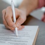Document with hidden glowing text revealed under ultraviolet light inspection