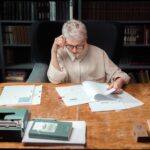 Robotic arm reading a document with hidden adversarial instructions on desk