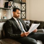 Auditor reviewing ISO compliance framework documents at corporate office desk