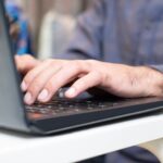 Security researcher typing prompt injection commands into a laptop terminal