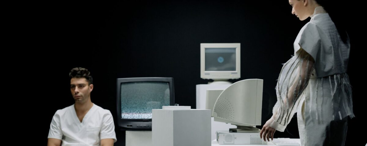 Computer monitor displaying a partially reconstructed face from machine learning model queries