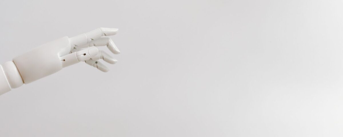 Robotic arm pressing keys on a glowing keyboard in server room