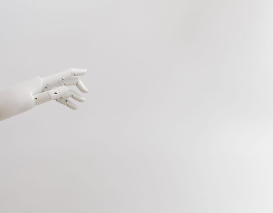 Robotic arm pressing keys on a glowing keyboard in server room