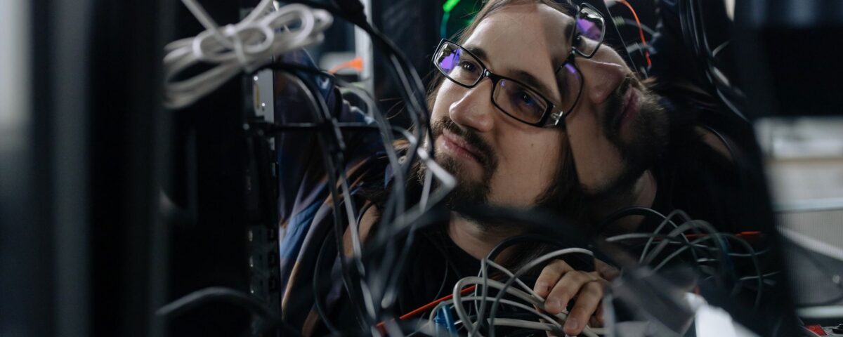 Engineer inspecting rack-mounted servers in a secured enterprise data center