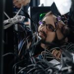 Engineer inspecting rack-mounted servers in a secured enterprise data center