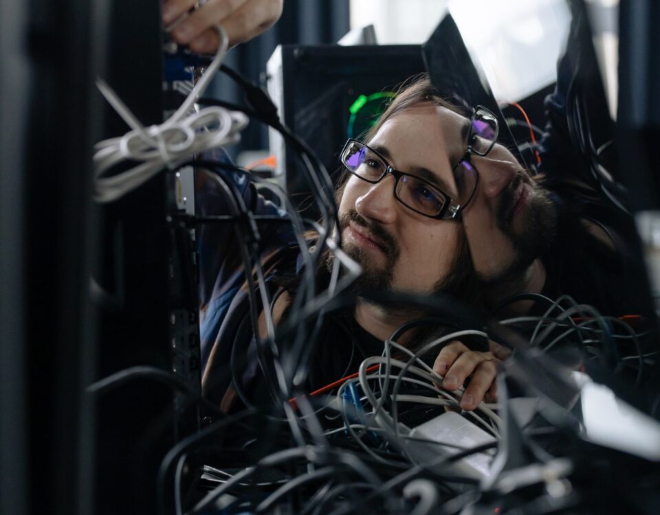 Engineer inspecting rack-mounted servers in a secured enterprise data center