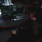 Security analyst reviewing LLM application code on dual monitors