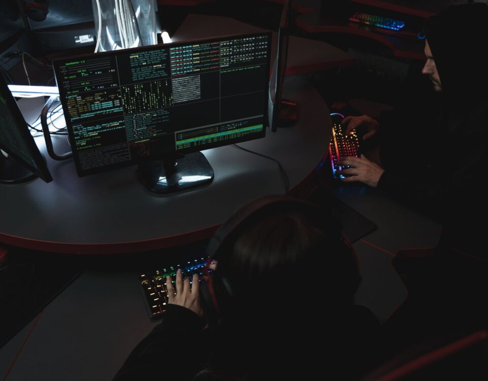 Security analyst reviewing LLM application code on dual monitors